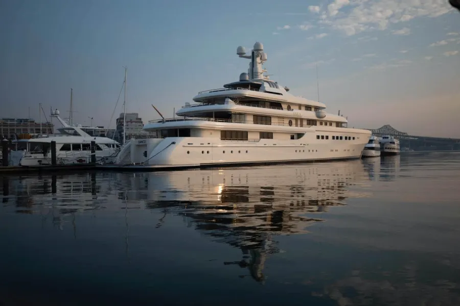 Yacht reflected in calm water at the marina